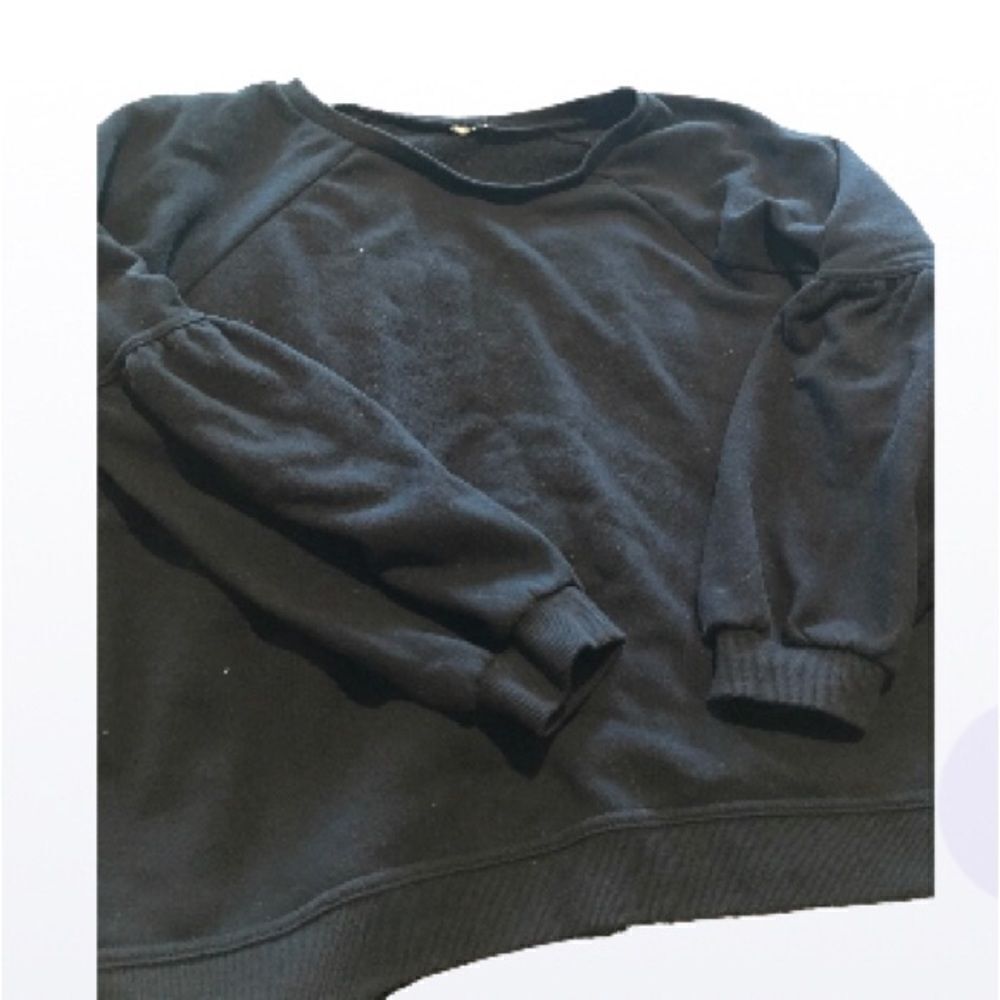 Kim Rogers size large black sweatshirt with pleated seams on the sleeves